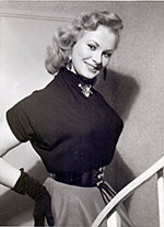 Sabrina in her six-button belt and black gloves
