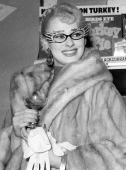 Sabrina as Dame Edna with specs, fur, gloves
