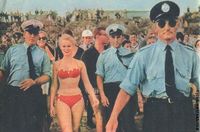 Sabrina in bikini surrounded by police