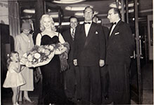 Sabrina with flowers, men and a girl
