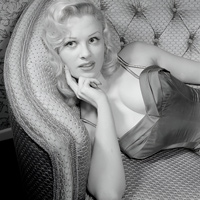 Sabrina being thoughtful on a couch