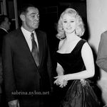 /sabrina/pix/sabrina-oz-melbourne-1958-10-black_dress-man-squint.jpg